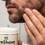 Close up of a man applying a lightweight pre shave gel to his stubble to prevent razor burn.