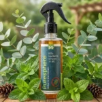 A bottle of Care14 PureSphere antibacterial room spray on a wooden table next to green herbal leaves.