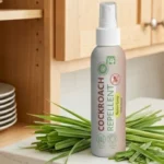 A kitchen counter free of pests next to a natural cockroach repellent bottle with fresh lemongrass leaves.